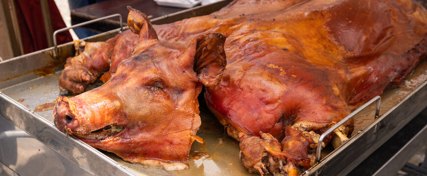 Whole roasted pig (chancho, hornado) in traditional cuisine restaurant. Traditional Ecuadorian Roast Pig &ldquo;Chancho Hornado&rdquo; at a Food Market. Whole roasted pig, known as &ldquo;chancho hornado,&rdquo;