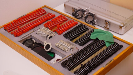 Close-up of a trial lens set used for eye exams in optometry, showing various corrective lenses in...
