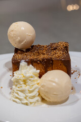 Honey toast, a Japanese dessert served with vanilla ice cream, chocolate sauce and whipped cream