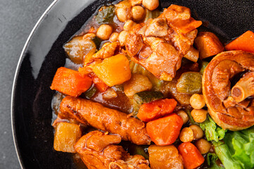 Ragout meat, sausages, vegetables stew dish fresh tasty food delicious gourmet food background on the table rustic food top view copy space