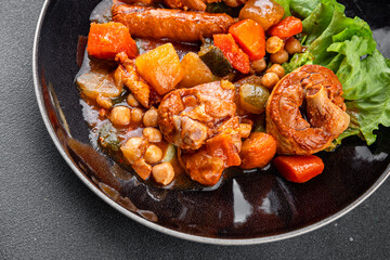 Ragout meat, sausages, vegetables stew dish fresh tasty food delicious gourmet food background on the table rustic food top view copy space