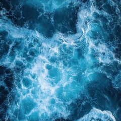 Fototapeta premium Aerial view of the turquoise ocean with white foam waves creating a mesmerizing abstract pattern and texture for a serene and calming background