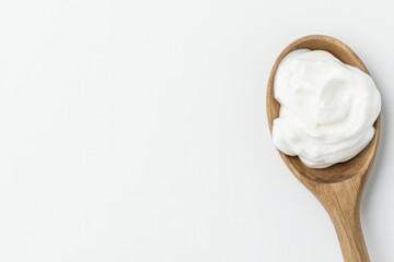 close-up image of rustic wooden spoon heaped with creamy greek yogurt on pristine white background offering ample copy