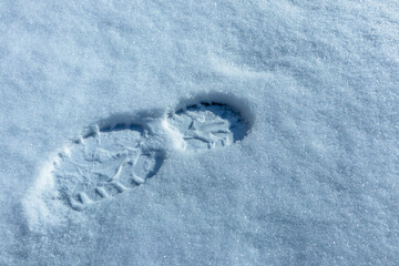 Boot print on clean snow. A human footprint on snowy ground
