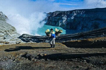 Suphur miner carrying a load of suphur at the Kawah Ijen crater