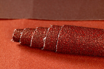 red coarse-grained sandpaper for working with wood and metal