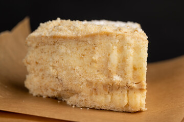 layered cake with white sweet cream on a board