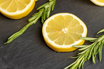 ripe juicy yellow lemon on a black slate board