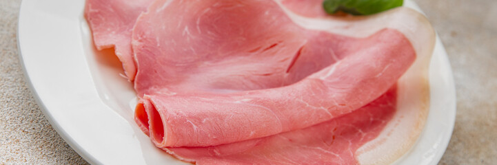 Ham slices pork meat delicious gourmet food background on the table rustic food top view copy space