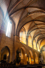 Colored vaults of the nave, illuminated by the stained glass windows, of the Abbey of Saint-Pierre...