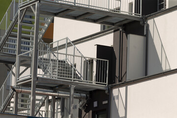 Fototapeta premium A fire escape is securely attached to the side of a tall building, providing crucial access for emergency exit during fires or other emergencies