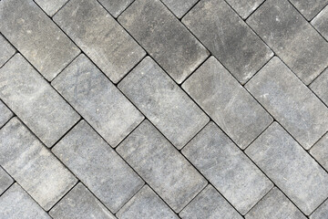 Gray concrete or stone pavers forming herringbone pattern