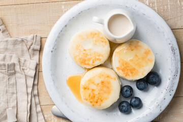 Cottage cheese fritters served with blueberries and caramel sauce