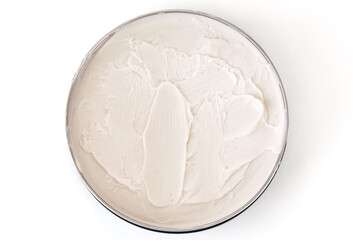 Jar of cosmetic cream close up on a white background