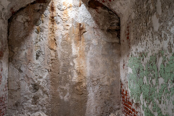 Chipped and peeling lead based paint on an old wall.