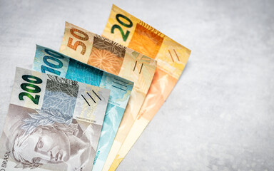 Brazilian reais money on gray tabletop. Financial background. Copy space, close up. flat lay