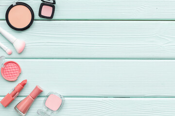 Makeup accessories - brushes and pink pastel cosmetic products, flat lay, top view