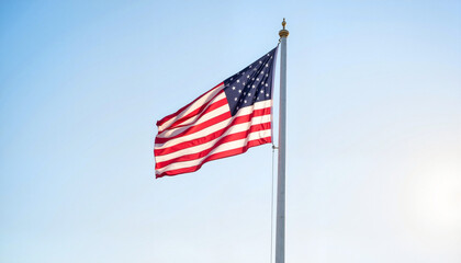 Obraz premium Flag at half-mast waving in clear skies, honoring solemnity