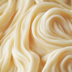 Close-up of creamy, swirling, pale-yellow substance.