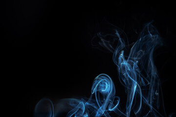 Blue smoke swirls in abstract form, photography style on black background. Concept of mystery and...