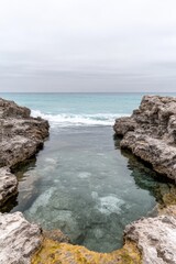 Coastal rock pool, tranquil scene, calm ocean view, natural hidden cove