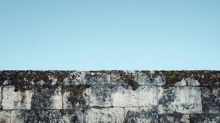 Ancient Stone Wall Against Clear Blue Sky - Architectural Background