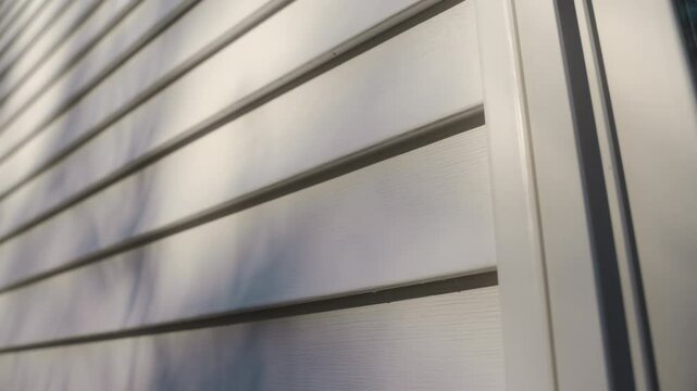 White siding house wall with clean, modern panels, providing a sleek and classic exterior look