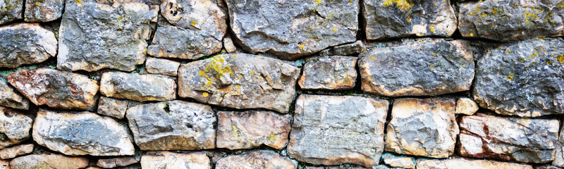 Wide shot of handmade stone wall background.Natural stone background.