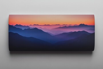 Serene sunset over a vast, layered mountain range, bathed in hues of orange, purple, and blue.