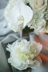 White flowers arranged beautifully with delicate petals on a silk background during a serene indoor event