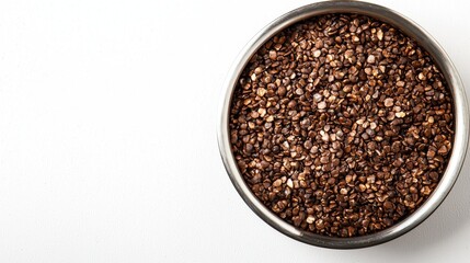 Teff porridge in stainless steel pot viewed from above on solid white background