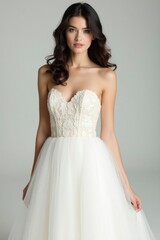 Fototapeta premium Woman Posing in Elegant Strapless Wedding Dress with Floral Lace Bodice