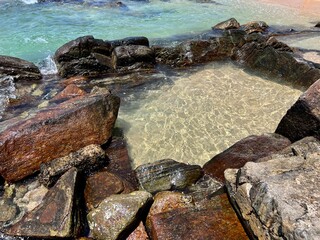 Fototapeta premium natural rock pool in the ocean in blue clear water on a sunny day