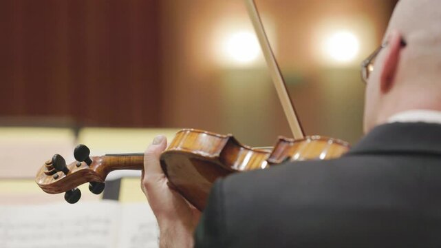 Musician playing violin during classical music concert