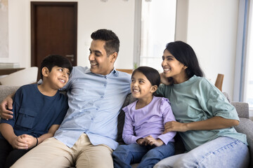 Heartwarming family interaction. Indian couple and their two kids lead pleasant conversation...