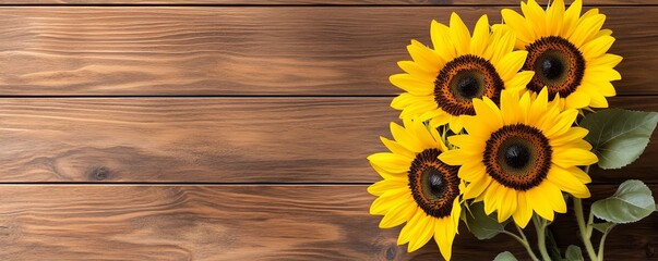 Obraz premium Cheerful sunflower bouquet placed on a warm walnut wooden surface