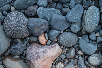 Mosaic of river stone rounded due to weathering by the flowing water of Hell Roaring Creek, Yellowstone National Park