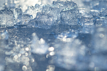 Beautiful transparent different pieces of ice on the ice surface. Pieces of ice filled with...