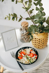 Vegetable salad in a round black plate