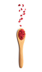 spoon with dry raspberries on white background