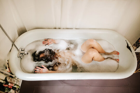 Woman underwater in clawfoot tub