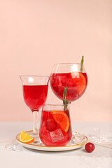 Glasses of grape cocktail, red wine and juice with grape berries, ice and citrus slices on sunny background, bar and summer party concept, restaurant and cafe advertising card, minimal flyer card