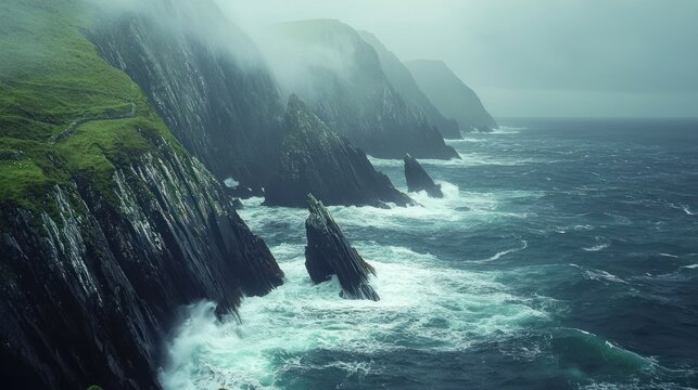 Dramatic coastal cliffs with crashing waves in foggy weather.