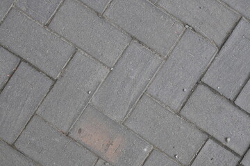 A brick patterned floor with a few bricks missing