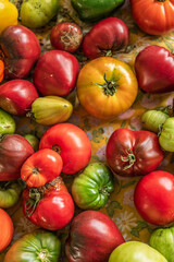 Colourful assortment of tomatoes and peppers on a table.