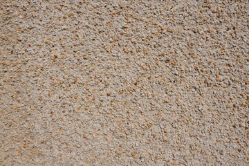 A wall with a lot of small rocks on it