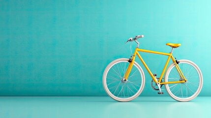 Yellow bicycle with white tires against a teal wall.