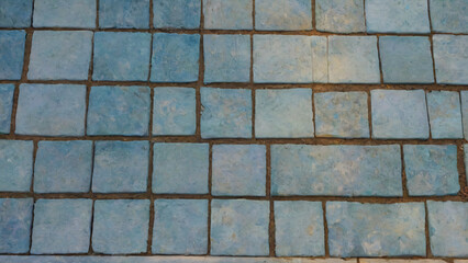 Old, broken blue tile floor