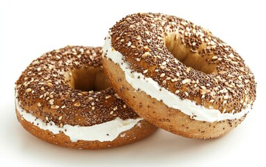 Two everything bagels with cream cheese, on white background. Close-up, studio shot. Food photography