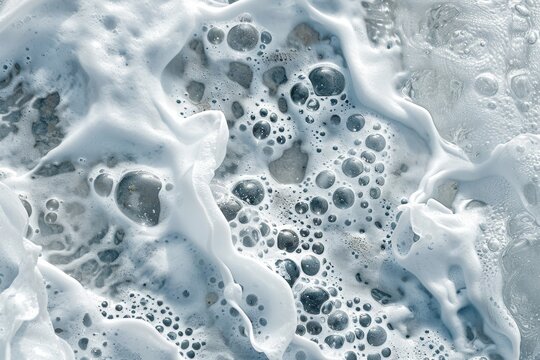 Close-up of foamy ocean waves crashing against the shore, The intricate patterns of foam on the surface of the water